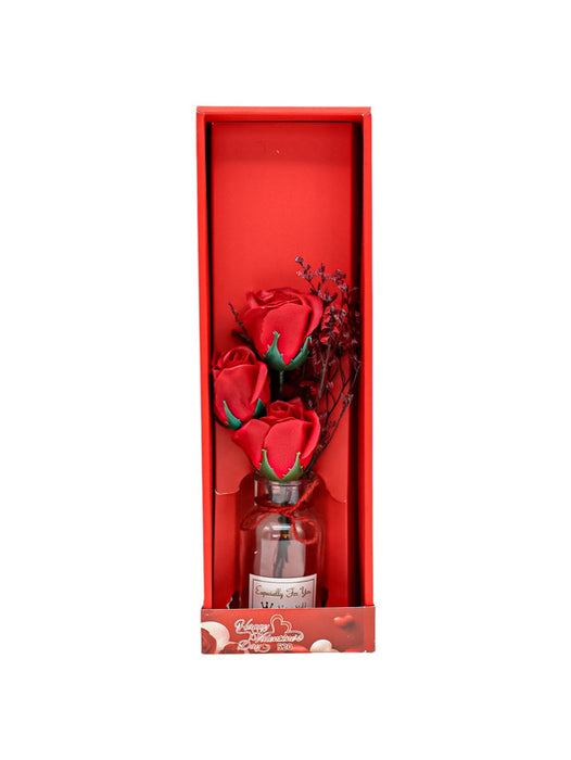 Caja con tres flores de rosa artificial en colores varios con frasco de vidrio para obsequio