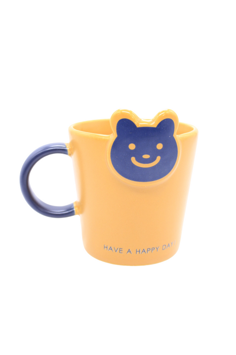 Taza de cerámica con cuchara diseño osito sonriente en colores varios para café o té