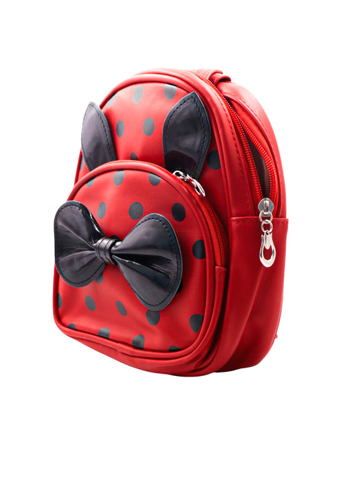 Mini mochila para infantes en colores varios con lunares en negro y decorada con un liston y orejitas en terminado glossy